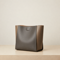 Graphite leather structured tote bag on a warm neutral background